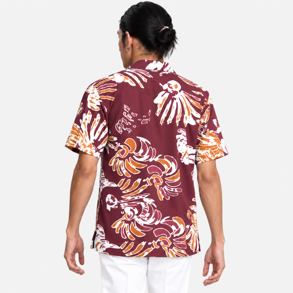 Man wearing maroon printed batik facing back