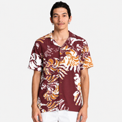 Man wearing maroon printed batik shirt, facing the front