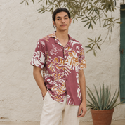 Man wearing maroon shirt standing outside