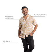 Man wearing batik shirt with beige patterns