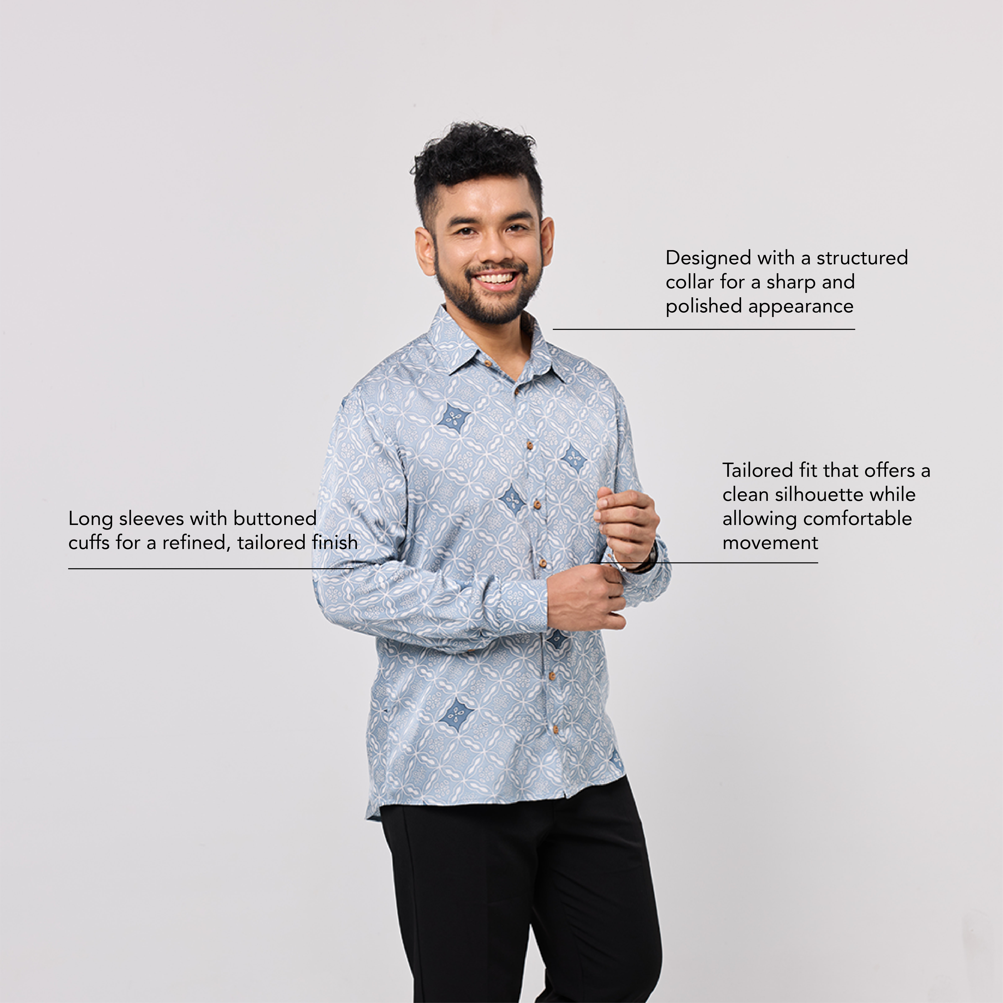 Man wearing a patterned shirt with text describing its features on a light gray background