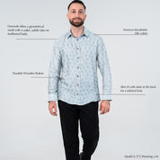 Man wearing a light blue patterned shirt with text describing features on a white background