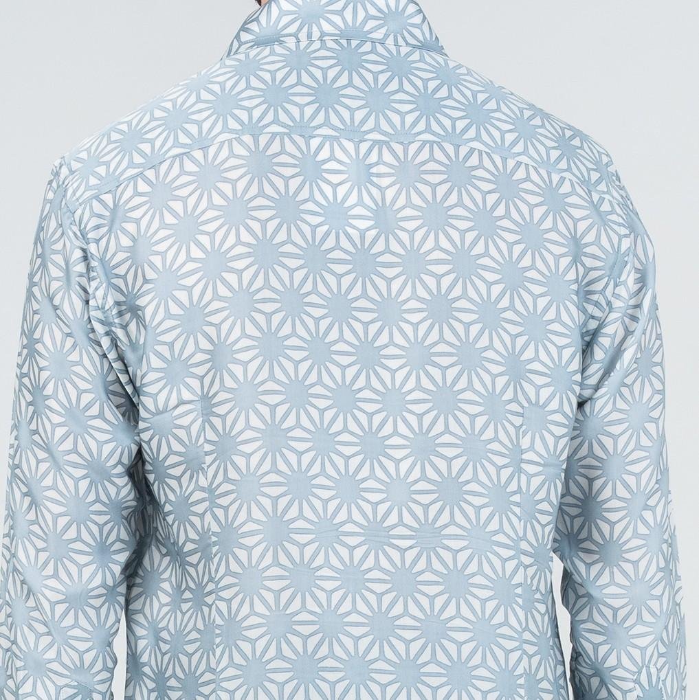 Light blue geometric patterned shirt on a light gray background
