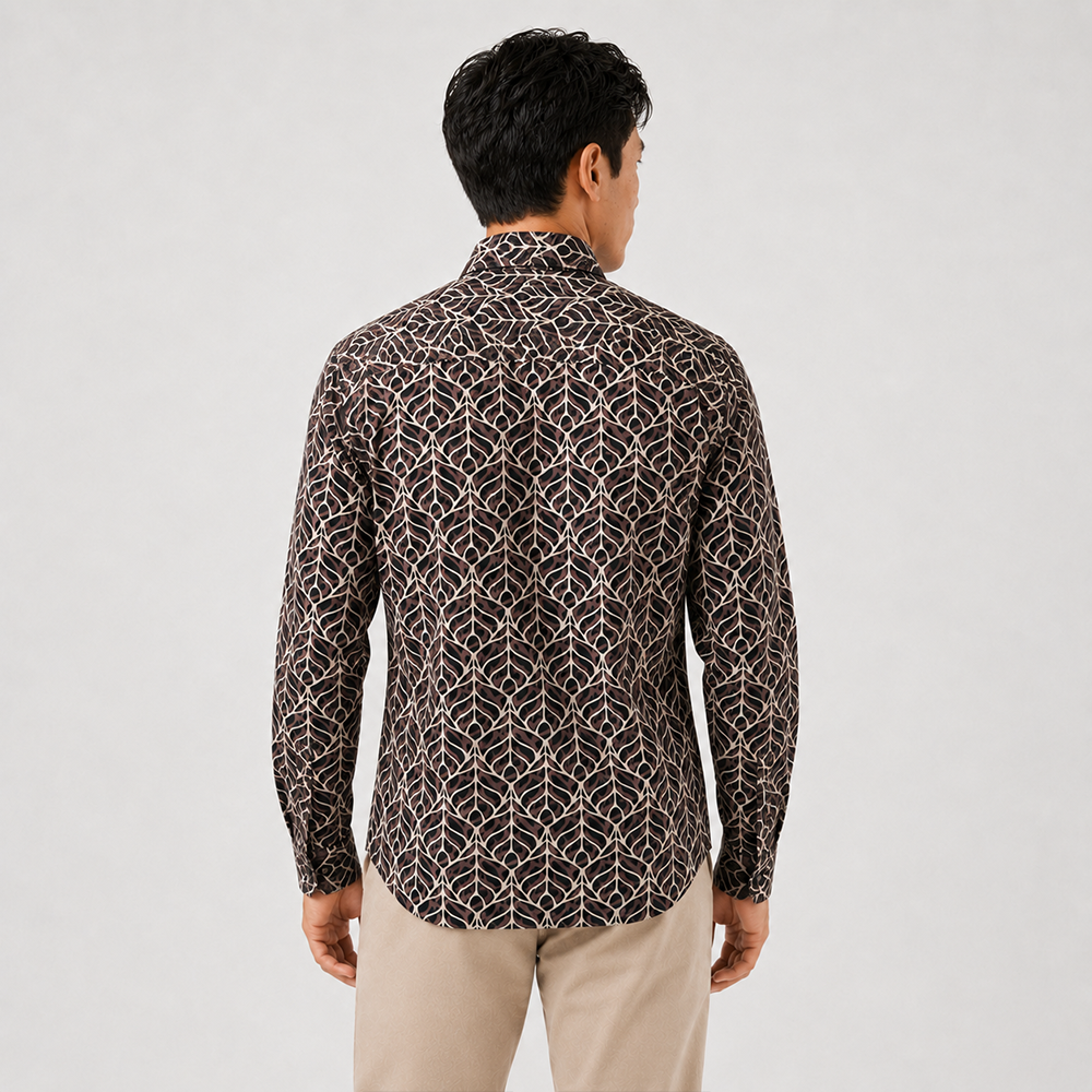Man wearing a patterned shirt and beige pants on a light gray background