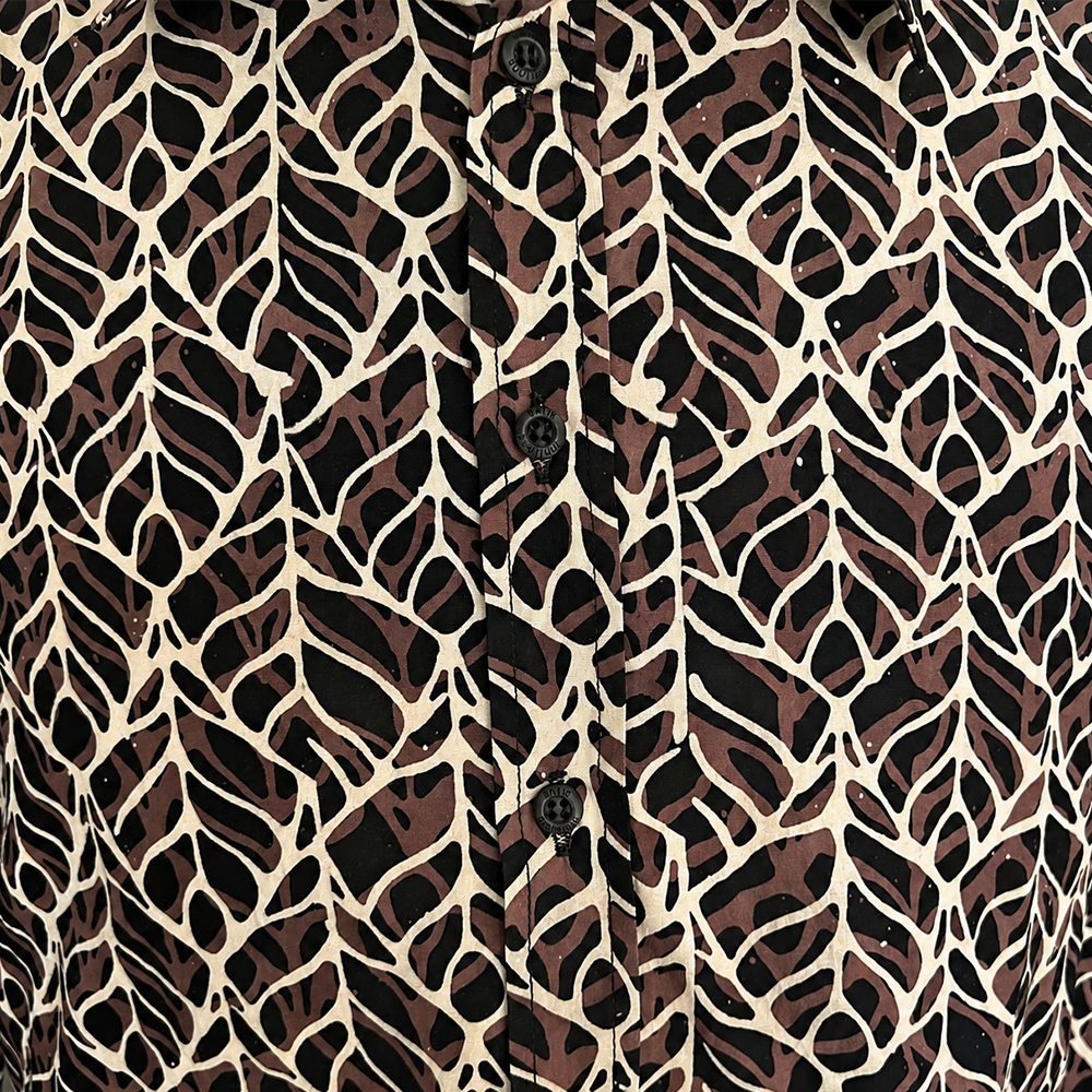 Patterned shirt with a leaves-like design on a beige background