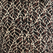 Patterned shirt with a leaves-like design on a beige background