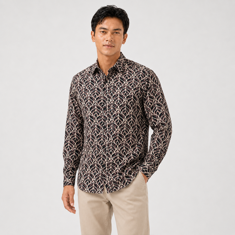 Man wearing a patterned shirt and beige pants on a white background