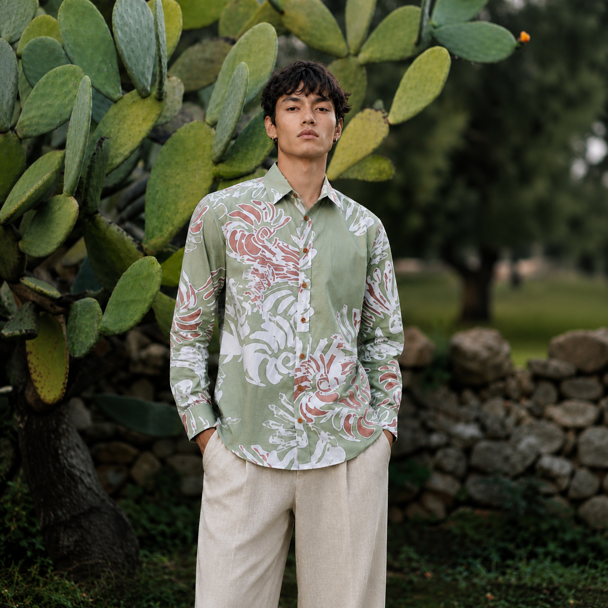 Man wearing a patterned shirt and pants leaning outside