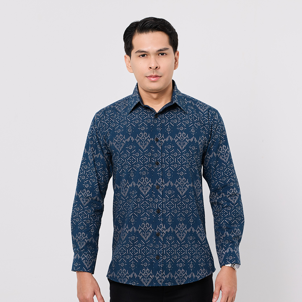 Man wearing a blue patterned shirt on a white background