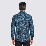 Man wearing blue printed batik shirt facing the back
