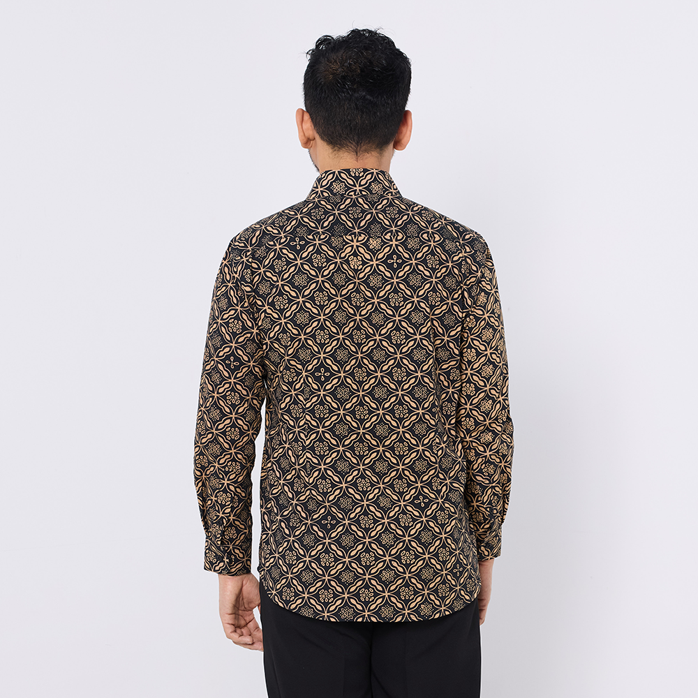 Man wearing a patterned shirt on a white background