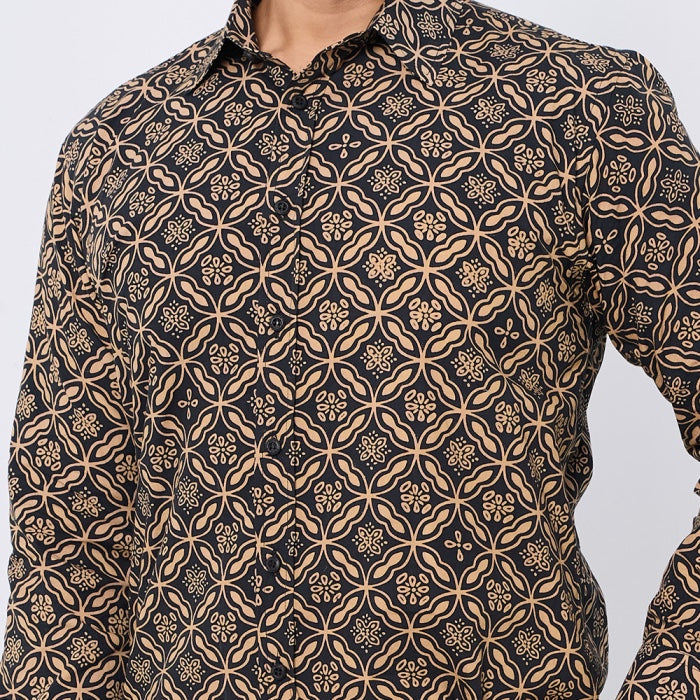 A close-up of a men's long-sleeve button-up shirt featuring an intricate geometric and floral block-print pattern in beige on a black background.