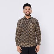 Man wearing a patterned shirt against a white background