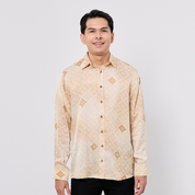 Man wearing a beige patterned shirt against a white background