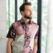 Model wearing the Men's Modern Batik Shirt  Maroon Petola in a lifestyle photo 