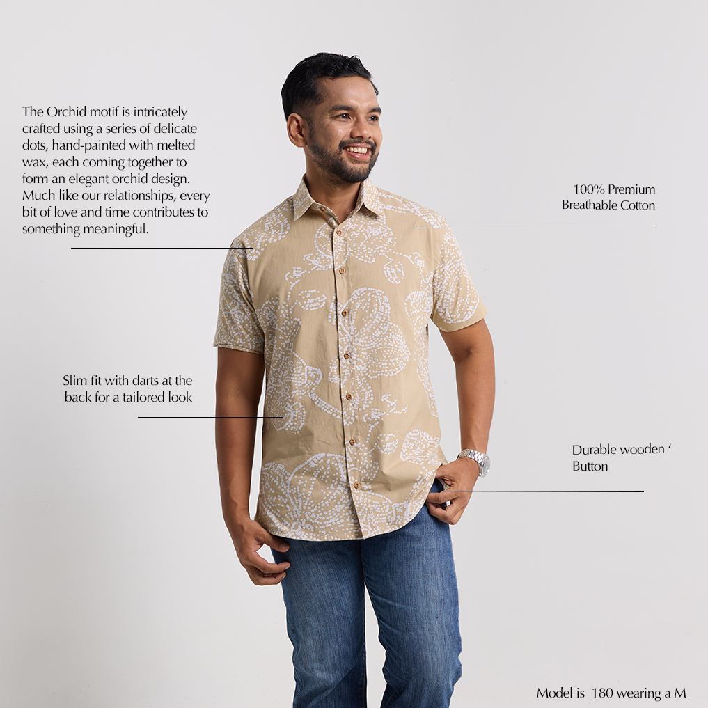 Man wearing a patterned shirt with text describing its features on a light gray background