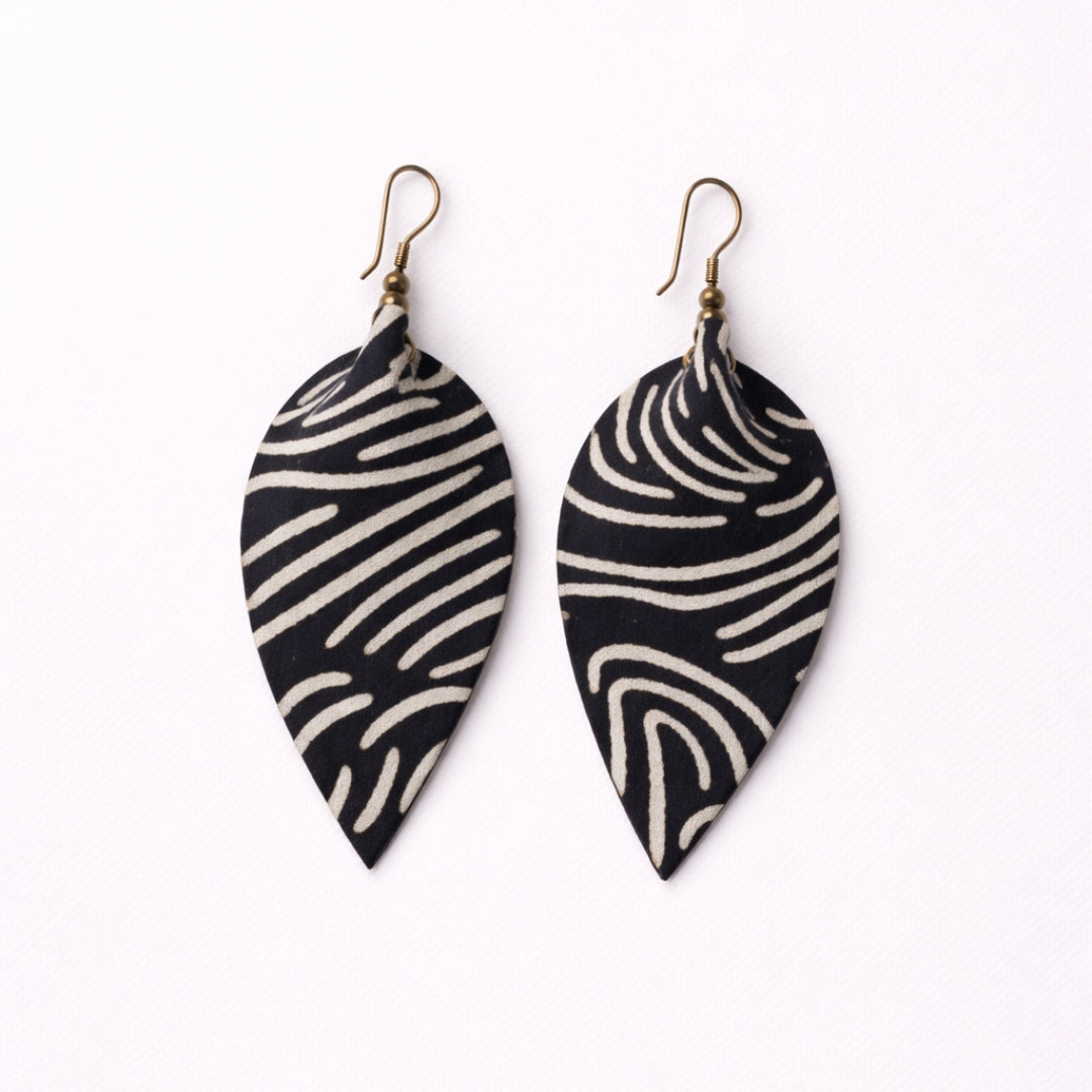 Black and white patterned leaf-shaped earrings on a white background