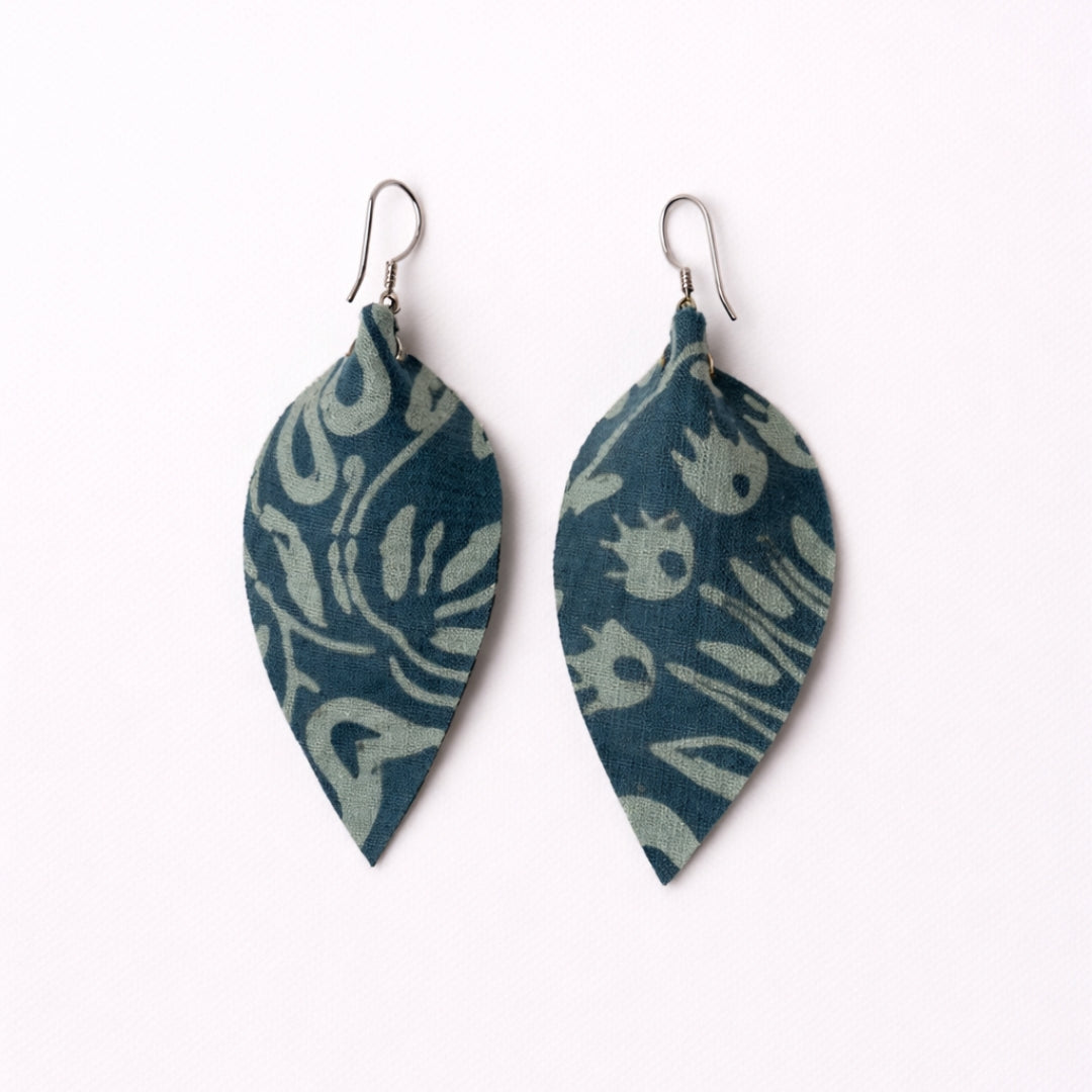 Pair of blue patterned leaf-shaped earrings on a white background