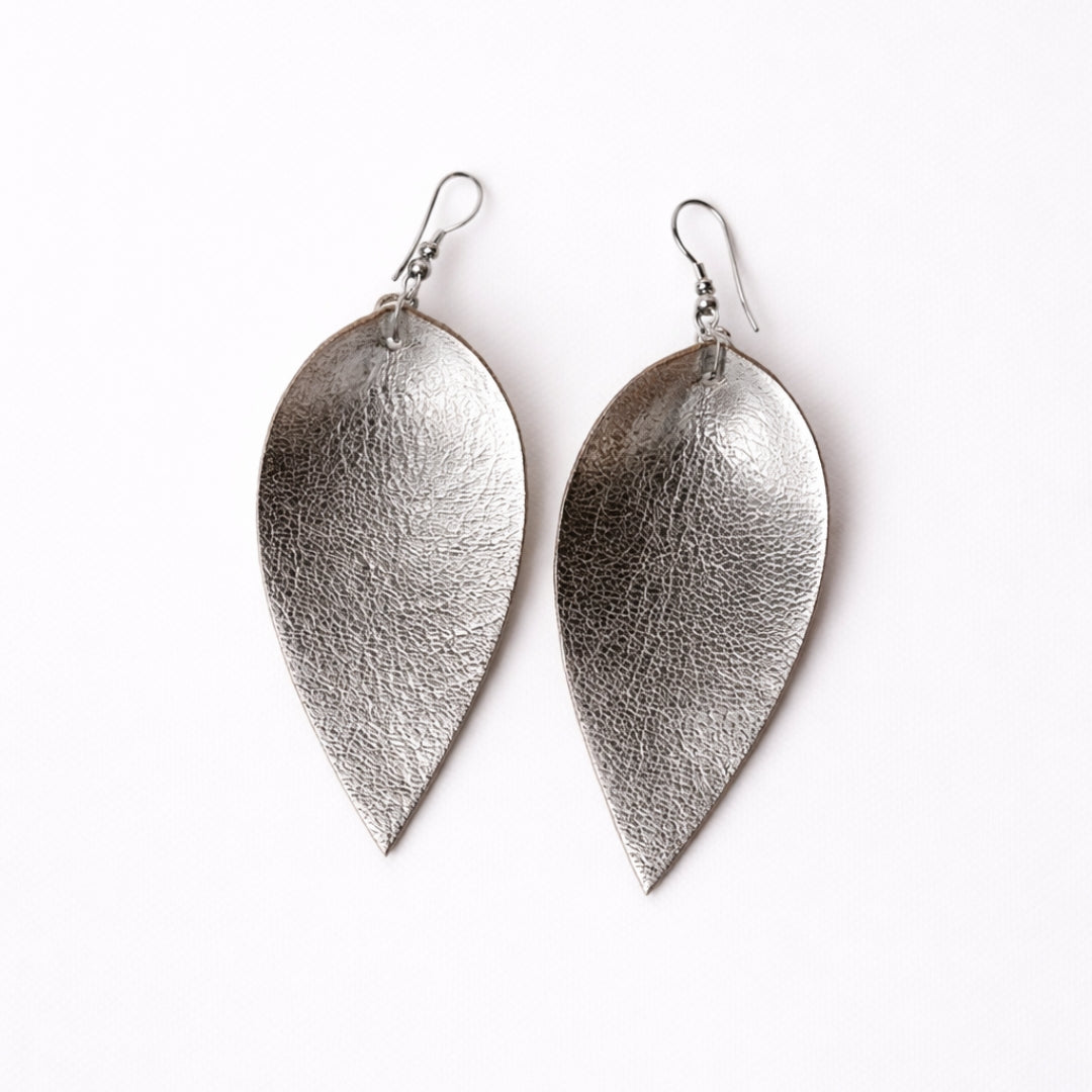 Pair of silver leaf-shaped earrings on a white background