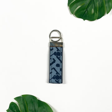 a picture of midnight arabesque key fob made of batik remnants against a neutral background