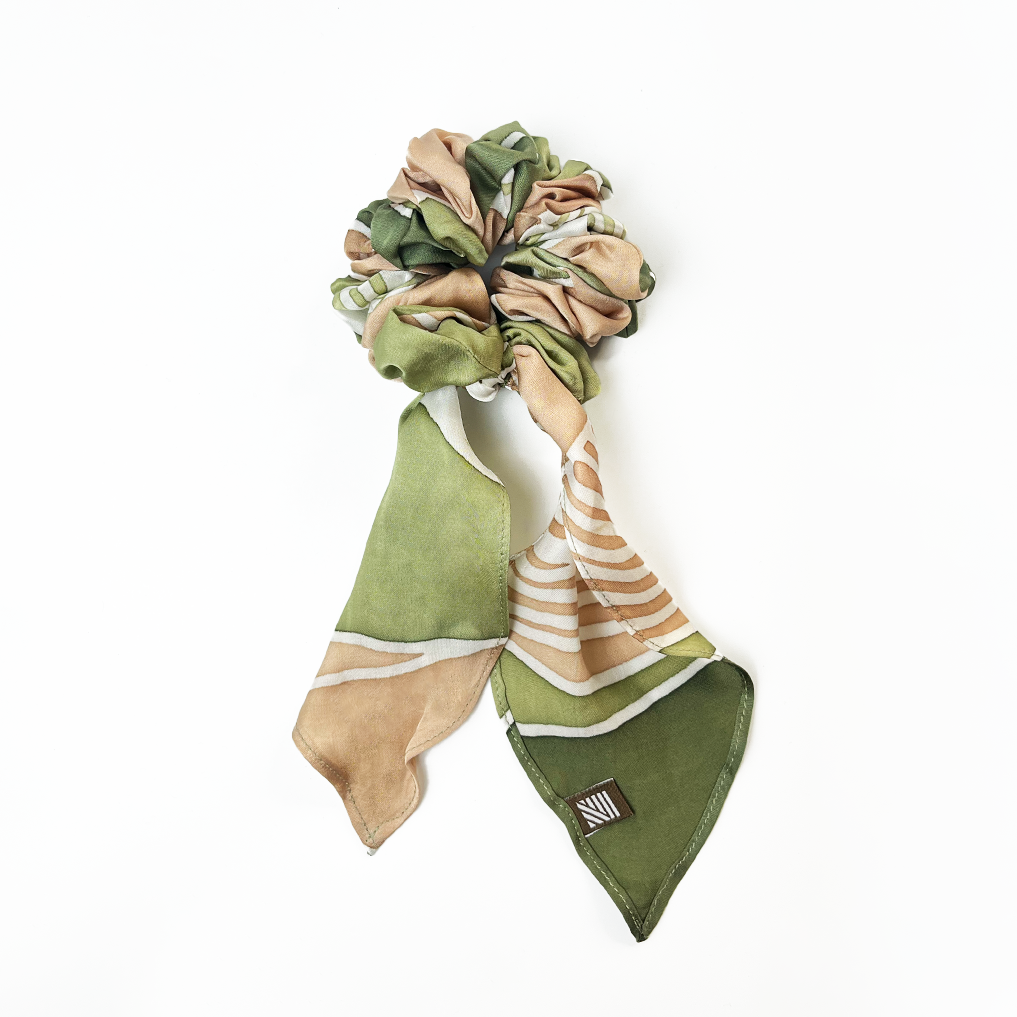 Moss Bukit batik scrunchie with ribbon tail on white background.