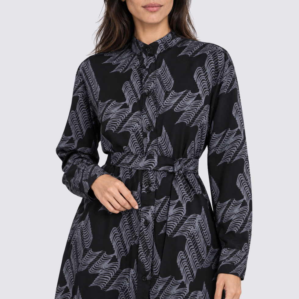 Closeup of woman wearing black printed batik dress