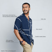 a man wearing a batik shirt against a white background in navy brush