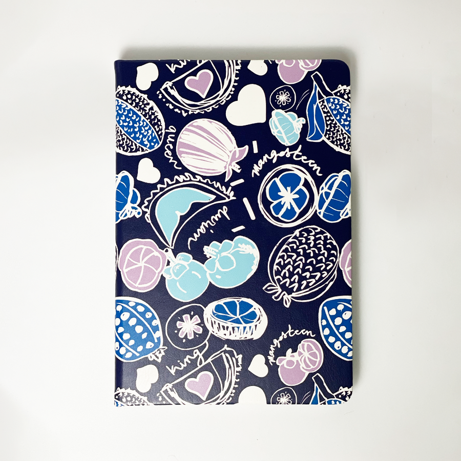 A photo showing batik-inspired leather notebook in navy durian print