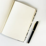 Batik-Inspired Notebook & Pen - Black Floret showing the cream colored pages 