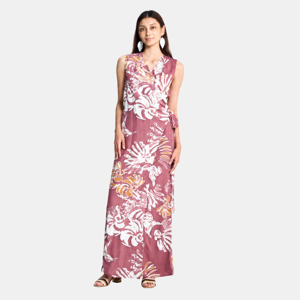 A woman modeling a sleeveless wrap-style maxi dress with a tie waist and an abstract light maroon and off-white pattern, set against a plain light gray studio background.