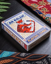 Playing card box with tiger design on a patterned surface

