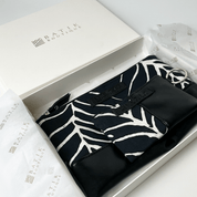 Black and white patterned belt in a Batik Boutique box