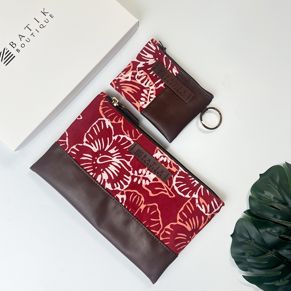 Two batik-patterned pouches with brown accents on a white background, featuring the Batik Boutique logo.