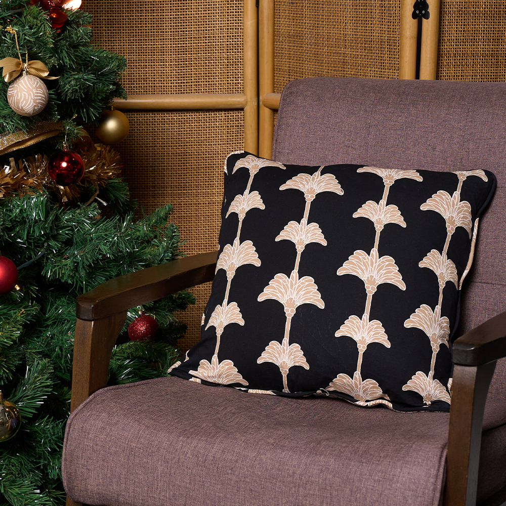 black coconut pillow cover with christmas tree on a sofa