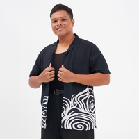 a male model, aizat amdan, posing in a batik shirt in the pattern black kerepek in the pattern black kerepek