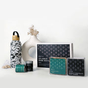 Collection of tea packaging and decorative items on a white surface with a light gray background.