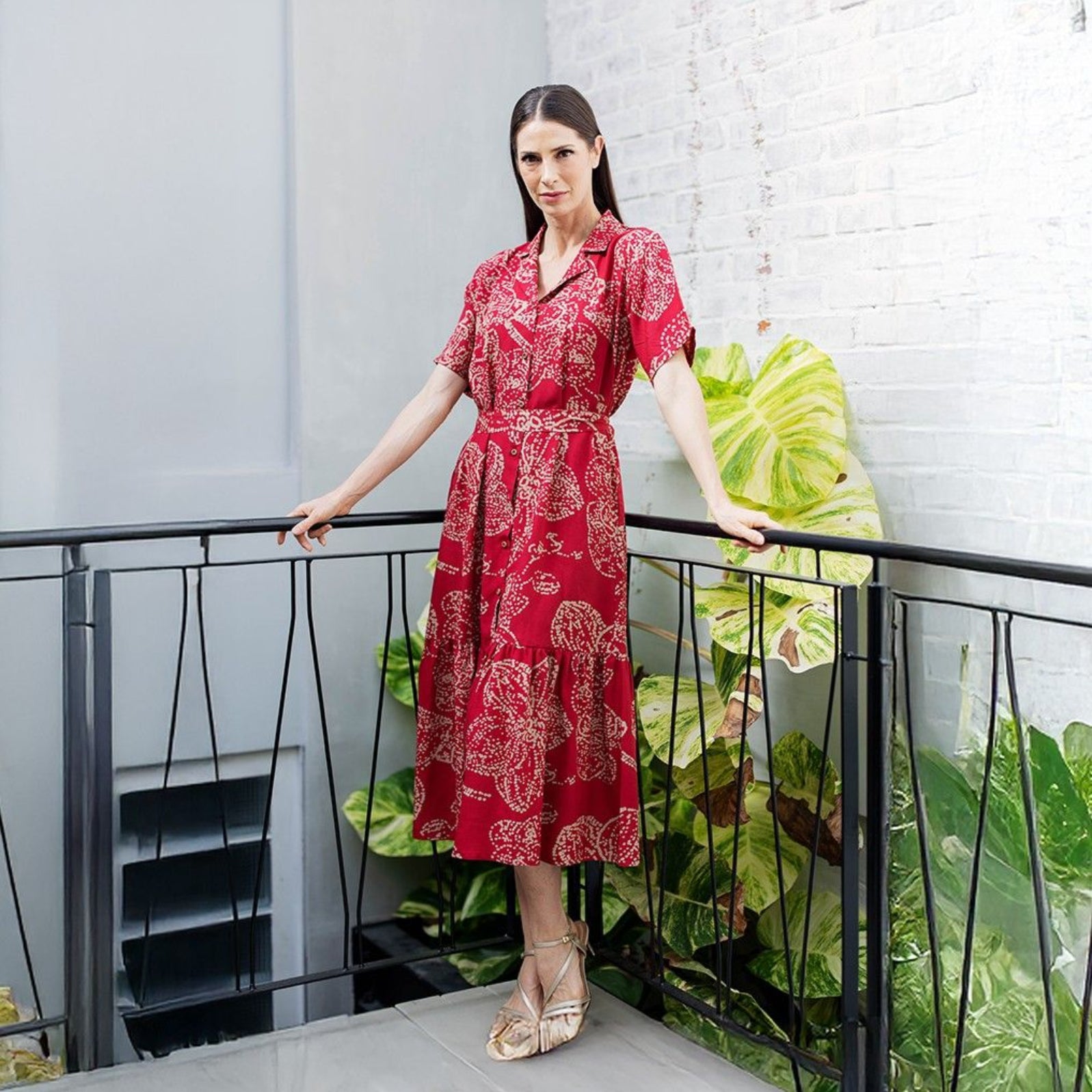 Women wearing red orchid button up dress 