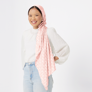 a woman model posing in a batik scarf in the pattern peach bloom