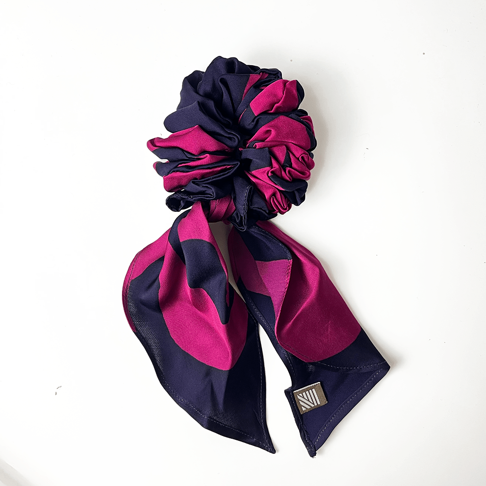 Navy and pink hair scrunchie with matching color fabric with a white background