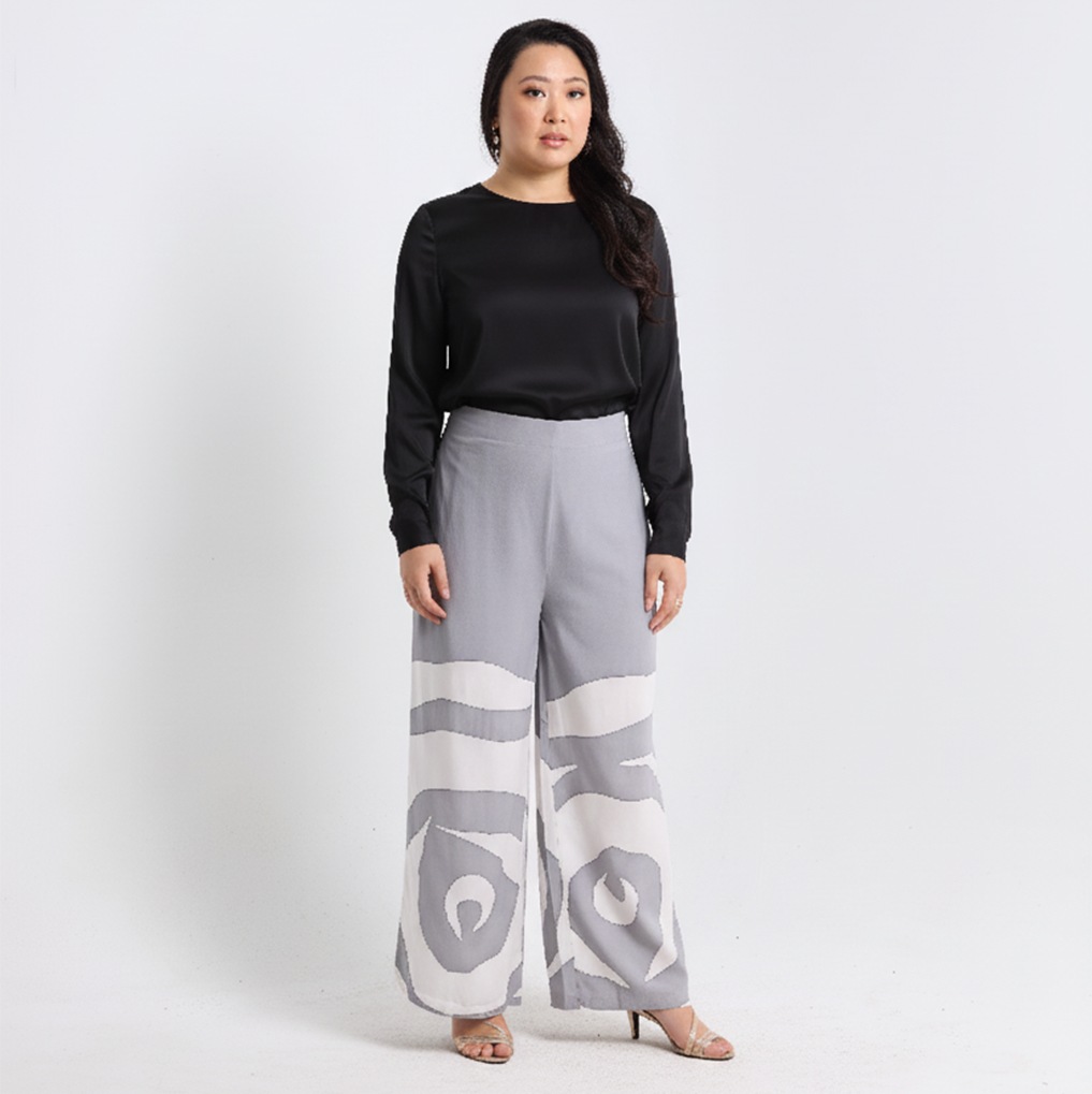 Woman wearing a black top and gray patterned pants on a white background
SilverRoseTrouser