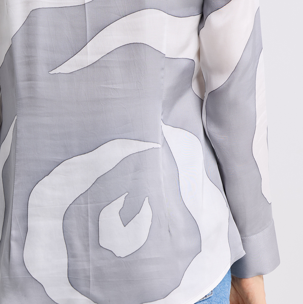 Gray and white abstract patterned fabric with a person wearing it.
SilverRoseWomens-Shirt-.