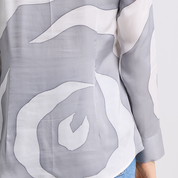 Gray and white abstract patterned fabric with a person wearing it.
SilverRoseWomens-Shirt-.