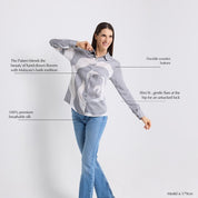 Woman wearing a gray and white patterned blouse with text describing its features on a light gray background
