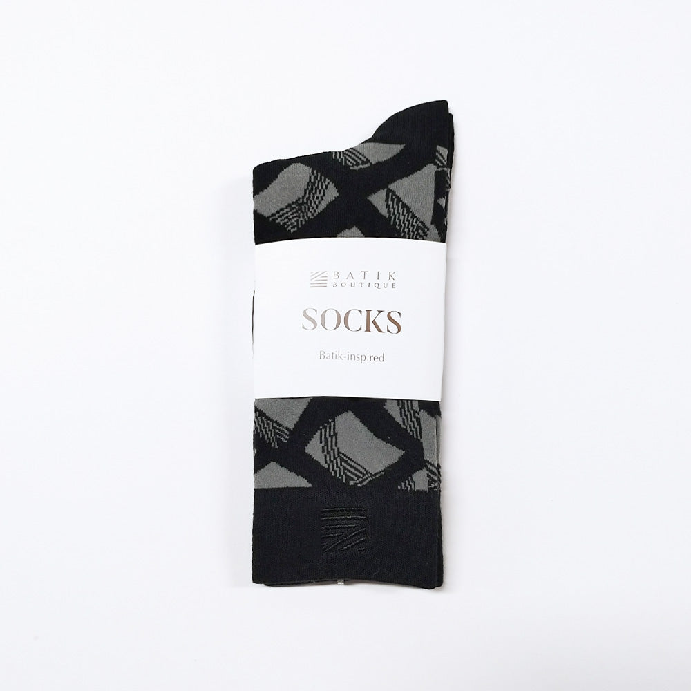 a whitebox photo of black and grey motif with the sleeve saying "socks, batik-inspired" with batik boutique logo