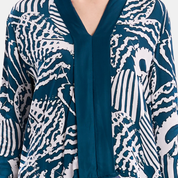 Closeup up of a woman wearing blue printed batik kebaya top