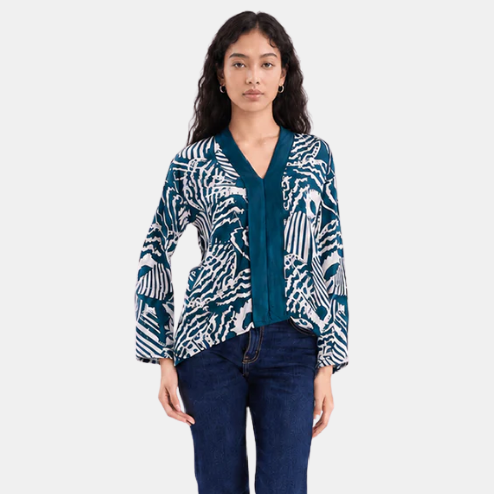 Woman wearing blue printed batik kebaya top, facing the front, showing the features of the front side of the top