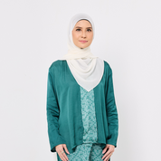 Woman wearing a green outfit with a white hijab on a white background