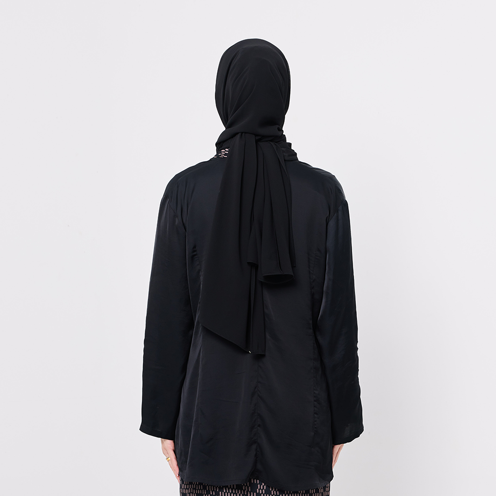 Person wearing a black hijab and black outfit on a white background