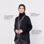 Woman wearing a black outfit with a batik pattern on a white background