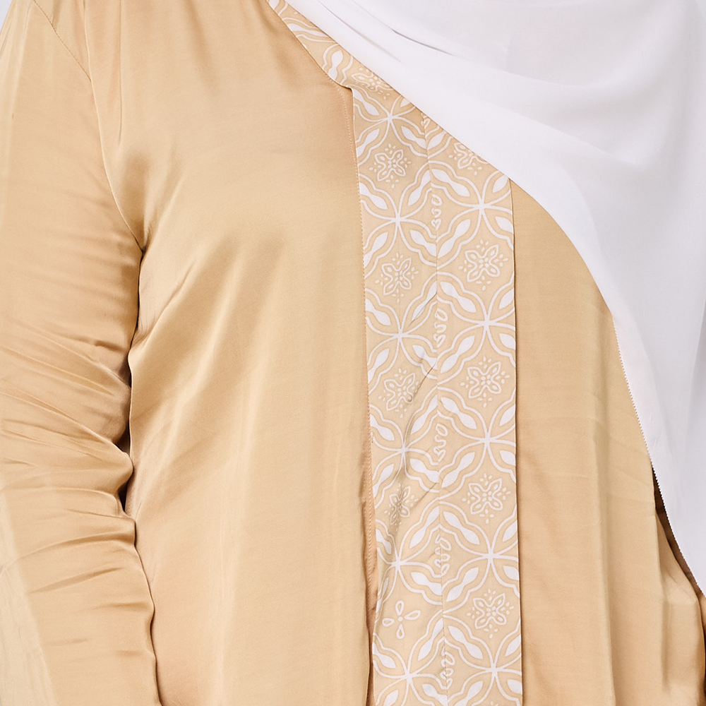 Close-up of a beige garment with white floral pattern